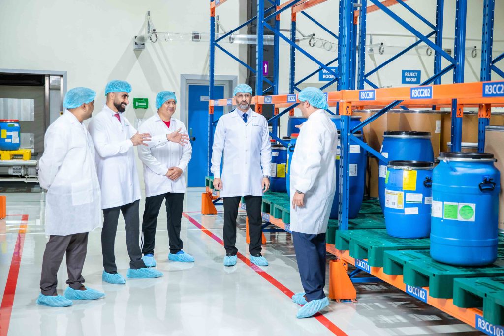 Team inspecting epoxy self-level flooring in a warehouse and storage racking facility